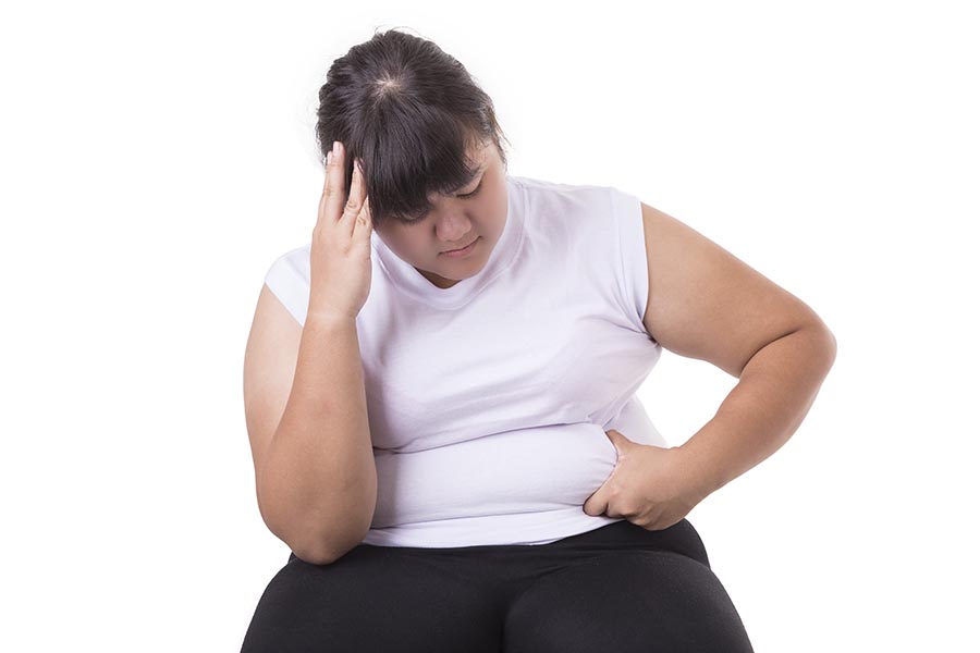 Fat Asian woman wear white t-shirt worried about her body size